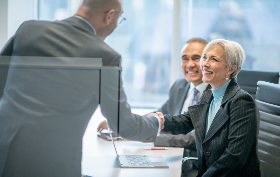 Salesperson shaking hands with potential new client